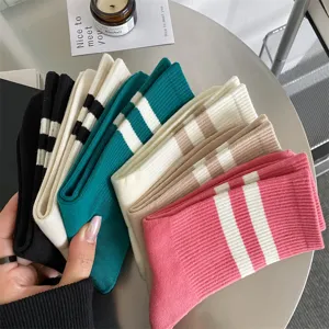 Detailed view of women ribbed mid-tube socks with classic double stripe design in multi colors.