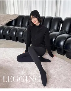 Detailed view of cozy black fleece-lined footed tights in a modern indoor studio scene.