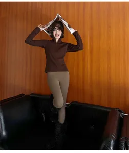 Detailed scene view of stylish women's warm thermal winter leggings in brown, cozy fit.
