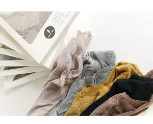 Detail view of women thermal underwear featuring delicate lace v-neck in multiple colors.