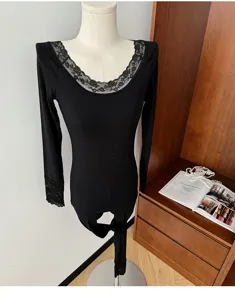 Detail shot of black lace thermal underwear set featuring V-neck long sleeve top and pants.
