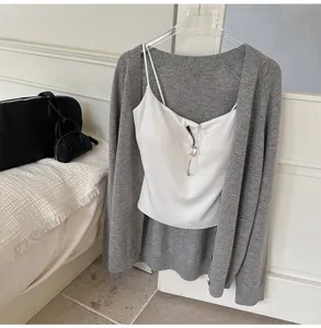 Detailed view of the cozy grey knit cardigan and white camisole set, soft texture and comfy design.