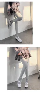 Close-up detail shot of women's warm grey thermal leggings styled for cozy winter outfits.