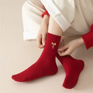 Red cotton women socks with gold bow embroidery, warm winter knit ribbed hosiery for daily wear.