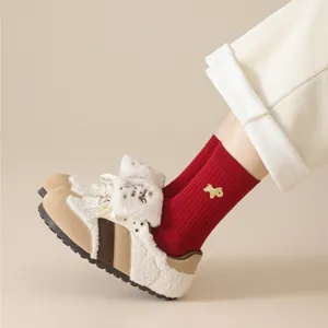 Cozy winter fleece casual shoes paired with bright red knit socks featuring cute animal embroidery.