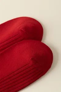 Close-up detail of red ribbed cotton socks showing fine knit texture and quality fabric.
