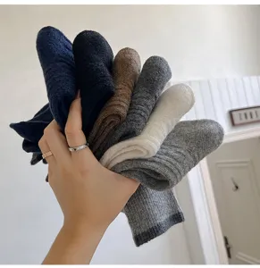Cozy wool blend mid-tube socks for women, featuring cable knit pattern and chic contrast cuffs.