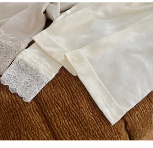 Detailed view of women's thermal underwear set featuring delicate lace trim cuffs and soft knit fabric.