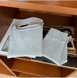 Detailed view of merino wool thermal underwear set in light blue, featuring square collar top.
