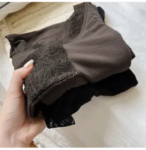 Detail shot of seamless lace thermal underwear set, soft knit fabric with elegant lace trim.