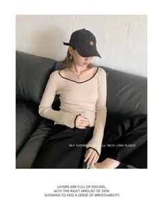 Detail view of silk cashmere long sleeve top, elegant seagull neck design, stylish base.