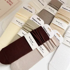 Detailed close-up view of solid color ribbed cotton mid-tube women socks with heels.