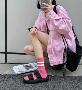 Pink mid-calf socks with white stripes detail, stylish women daily casual hosiery item.
