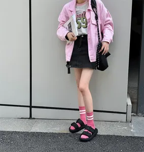 Detailed close-up shot of women's pink striped mid-tube socks styled in a stylish daily outfit.