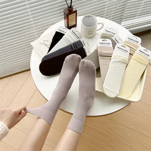 Women solid color ribbed cotton mid-tube socks detail shot showcasing soft fabric and cute style.
