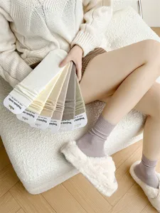 Women's autumn and winter solid color ribbed cotton mid-tube socks, cozy daily casual wear.