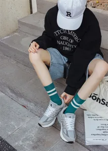 Women's autumn winter mid-tube socks with classic two-stripe design, comfortable cotton knit.