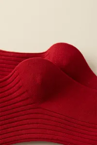 Red cotton ribbed knit socks detail showcase, soft texture and comfortable fit for winter wear.
