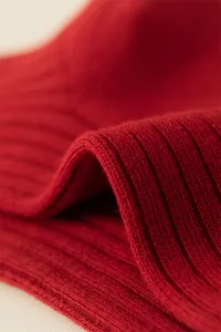 Red ribbed cotton sock detail, winter warm textile texture close-up shot for daily wear.
