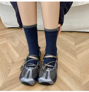 Women's mid-tube wool blend socks with contrast ribbed cuffs and cozy knit texture.