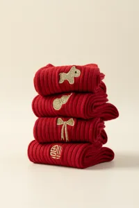 Detail shot of folded red cotton socks with cute gold embroidery for Chinese New Year.