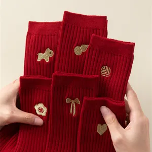 Red cotton festive socks with cute gold embroidery details, perfect for winter and special events.
