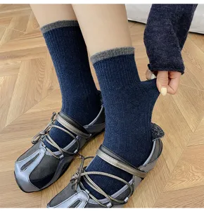 Close-up detail of women's cable knit wool blend crew socks with contrast grey cuffs.