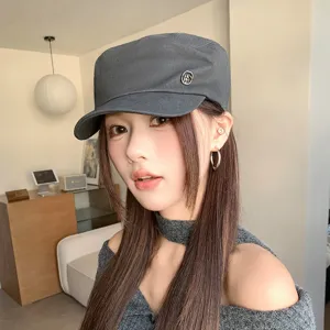 Japanese retro washed flat top cap for women, stylish casual cadet newsboy hat with metal logo.