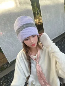 Cozy winter knit beanie for women, stylish purple striped design, thick warm woolen cap.