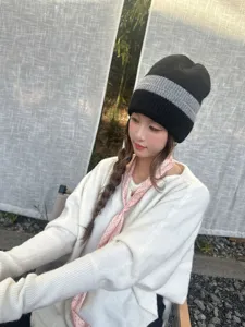 Detail view of the black and grey striped knitted beanie, warm winter hat for women.
