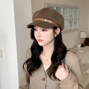 Chic brown woolen newsboy cap with stylish leather strap detail, perfect autumn and winter accessory.