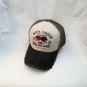 Close-up detail shot of vintage washed baseball cap with retro football text print.