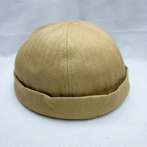 Nahaufnahme der khaki-Fischgräten-Docker-Mütze mit weichem Stoff und sauber gerollten Krempe.