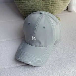 Grey baseball hat with LA embroidery and brim text, casual street style cotton cap.