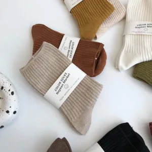 Detailed view of autumn winter solid color ribbed mid-calf cotton socks in Maillard shades.