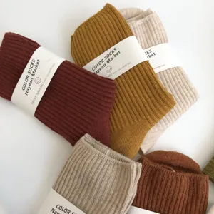 Minimalist ribbed cotton mid-tube socks in autumn earth tones, comfortable basic women daily wear.