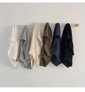 Detail view of seamless ribbed modal women briefs, hanging on wooden rack in multiple colors.