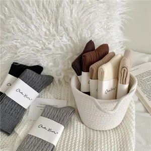 Thickened warm mid-tube women socks with cable knit design in brown Maillard tone for winter.