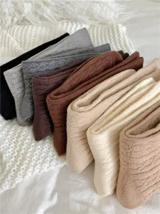 Cozy thick cable knit slouch socks for women, winter warm mid-calf hosiery in autumn colors.