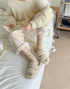 Cozy women's autumn winter thermal cable knit slouch socks paired with fluffy slippers.