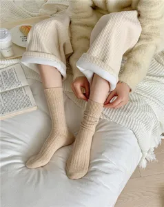 Cozy beige cable knit winter slouchy socks detail shot, warm thermal cozy home wear lifestyle.