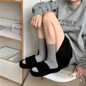 Comfortable thermal mid-tube women socks with cable knit design, soft and warm for winter wear.
