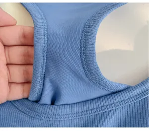 Close-up detail of blue ribbed knit camisole fabric and inner mesh lining craftsmanship.