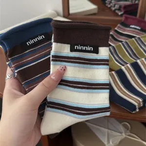 Retro striped rolled cuff women's socks with cute text label, soft cotton mid tube design.