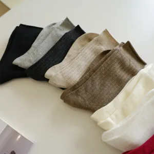 Detailed view of multiple colors ribbed cotton mid-calf socks arranged neatly for daily wear.