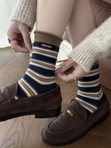 Retro striped cotton mid-tube socks featuring a rolled edge and cloth label detail.