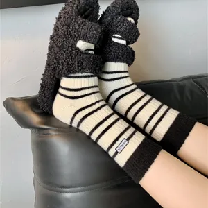 Winter thick warm striped mid-tube socks paired with fluffy plush slippers daily wear