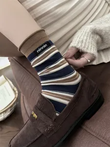 Women vintage striped cotton mid-tube socks with rolled edge and cloth label detail.