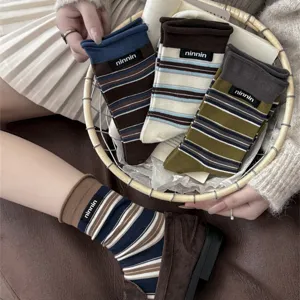 Vintage striped mid-tube socks with cute fabric label, soft cotton material for autumn.