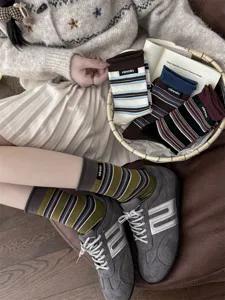 Women vintage striped cotton mid-tube socks featuring cute rolled edge and stylish labels.
